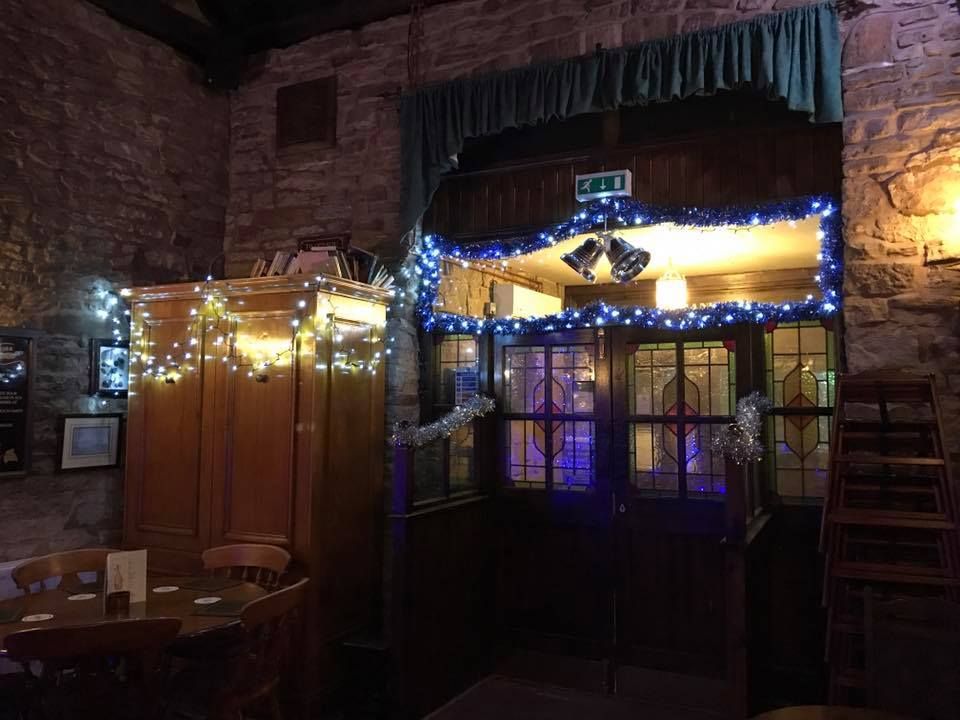 The bar at Christmas, with fairy lights round the stained glass