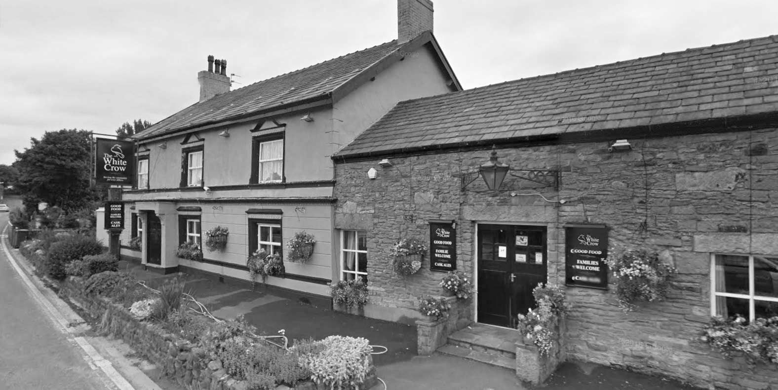 The White Crow today, in black and white, from across Chorley Road