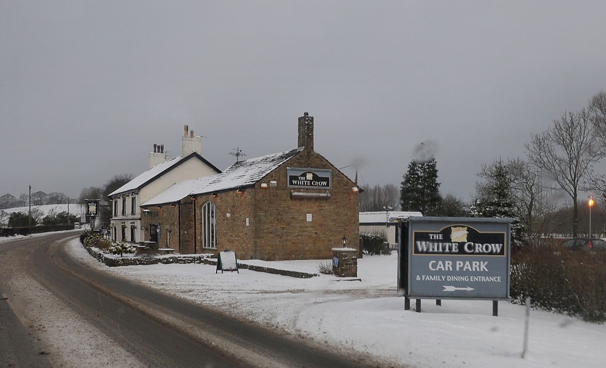 The White Crow car park sign pointing to the family dining entrance