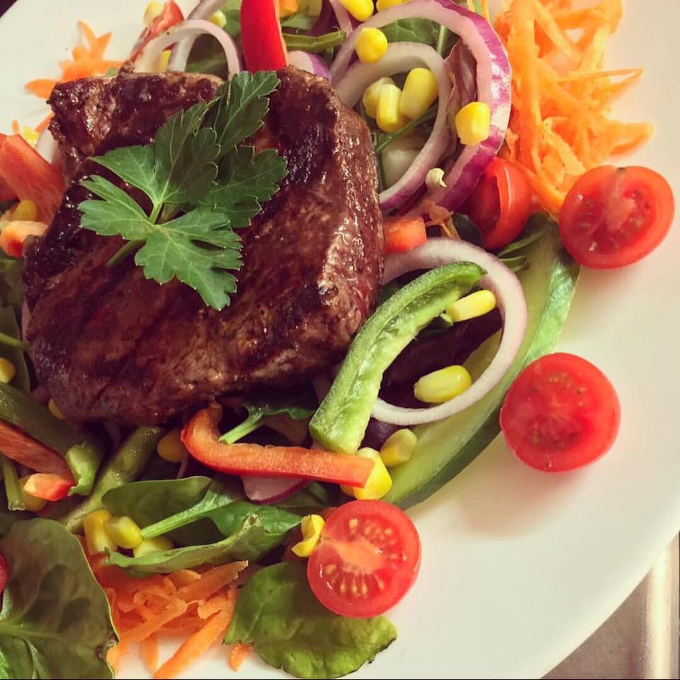 A chargrilled steak with salad